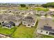 Overhead view of multiple homes with solar panels and backyard patios situated among lush green fields and horse pastures at 4216 Jespersen St, Apopka, FL 32712
