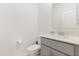 Clean bathroom with a toilet, sink, gray vanity with modern fixtures, and a mirror at 4216 Jespersen St, Apopka, FL 32712
