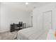 A bright bedroom featuring neutral walls, carpeted flooring, closet, a desk, a ceiling fan, and a comfortable bed at 4216 Jespersen St, Apopka, FL 32712
