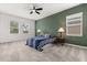 Cozy bedroom with a blue and white striped bed, a ceiling fan, and two bedside tables with lamps at 4216 Jespersen St, Apopka, FL 32712