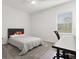 Cozy bedroom with gray carpet, complemented by a bed, desk, ceiling fan and a window that invites natural light at 4216 Jespersen St, Apopka, FL 32712