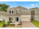 Charming two-story home with a cozy front porch and well-manicured lawn and a brick paver driveway at 4216 Jespersen St, Apopka, FL 32712