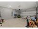 Spacious garage with concrete walls and floor, storage shelves and a sectional garage door to maximize space at 4216 Jespersen St, Apopka, FL 32712