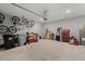 Garage equipped with ample storage, and tools, providing practical space for organization, as well as bikes hanging at 4216 Jespersen St, Apopka, FL 32712