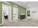 Hallway with open doorways, stylish console table with storage, and neutral carpet at 4216 Jespersen St, Apopka, FL 32712