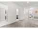 Upstairs hallway with laundry room, bathroom, and staircase access at 4216 Jespersen St, Apopka, FL 32712