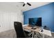 Functional office space includes modern desk setup, comfortable chair, and stylish blue accent wall at 4216 Jespersen St, Apopka, FL 32712
