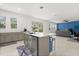 Open kitchen with a center island, stainless steel appliances, and a view into the living area at 4216 Jespersen St, Apopka, FL 32712