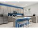 Modern kitchen features stainless steel appliances, a center island with seating, and gray cabinets at 4216 Jespersen St, Apopka, FL 32712