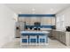 Modern kitchen features stainless steel appliances, a center island with seating, and gray cabinets at 4216 Jespersen St, Apopka, FL 32712