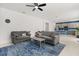 Living room boasts a ceiling fan, modern furniture, and a seamless connection to the adjacent kitchen at 4216 Jespersen St, Apopka, FL 32712