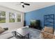 Bright living room featuring a ceiling fan, blue accent wall, and a comfortable seating area at 4216 Jespersen St, Apopka, FL 32712