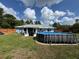Spacious backyard with lush lawn, patio, pool, and partial awning perfect for outdoor living at 4382 Sw 171St Pl, Ocala, FL 34473
