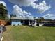 Charming blue home with a backyard oasis featuring lush lawn, patio, and pool at 4382 Sw 171St Pl, Ocala, FL 34473