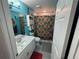 Colorful bathroom with vibrant blue walls, a patterned shower curtain, and vanity, creating a fun and inviting space at 4382 Sw 171St Pl, Ocala, FL 34473