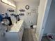 Well-lit bathroom featuring a vanity with a marble countertop, decorative shelving, and a neutral color scheme at 4382 Sw 171St Pl, Ocala, FL 34473