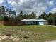 A blue single-story home with a fenced yard, well-kept lawn, and street corner location at 4382 Sw 171St Pl, Ocala, FL 34473