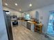 Bright kitchen with stainless appliances, butcher block counters, gray cabinets and tile floors, and a view to the backyard at 4382 Sw 171St Pl, Ocala, FL 34473