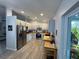 Well-lit kitchen featuring updated cabinetry, stainless steel appliances, butcher block countertop, and modern tile flooring at 4382 Sw 171St Pl, Ocala, FL 34473