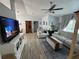 Bright living room with vaulted ceilings, fan, modern flooring, large windows, and comfortable seating at 4382 Sw 171St Pl, Ocala, FL 34473