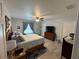 Comfortable bedroom featuring a queen size bed, ceiling fan, blue accents, and tile flooring at 4382 Sw 171St Pl, Ocala, FL 34473