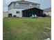 Spacious backyard featuring a screened patio and colorful adirondack chairs at 439 Sunfish Dr, Winter Haven, FL 33881