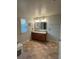 The bathroom features a double granite vanity, framed mirror, tile floors and natural light at 439 Sunfish Dr, Winter Haven, FL 33881