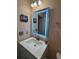 Modern bathroom vanity with illuminated mirror, white countertop, and stylish fixtures at 439 Sunfish Dr, Winter Haven, FL 33881