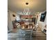 Open concept dining area with stylish light fixture, dining table and seating, and a view into the kitchen at 439 Sunfish Dr, Winter Haven, FL 33881