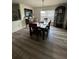 Bright dining room with wood floors, a modern light fixture and an antique grandfather clock at 439 Sunfish Dr, Winter Haven, FL 33881