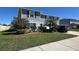Charming two-story home with blue siding, manicured lawn, and a paved driveway at 439 Sunfish Dr, Winter Haven, FL 33881