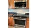 Modern kitchen with stainless steel microwave and oven, attractive backsplash, and wood-look cabinets at 439 Sunfish Dr, Winter Haven, FL 33881