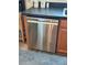 Contemporary kitchen featuring a stainless steel dishwasher, wood-look cabinets, and neutral countertops at 439 Sunfish Dr, Winter Haven, FL 33881