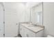 Bathroom with double sinks featuring granite countertops and a mirrored wall at 4545 Cross Prairie Pkwy, St Cloud, FL 34772