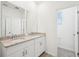 Bathroom showcases double sinks with granite countertops, adjacent to the water closet at 4545 Cross Prairie Pkwy, St Cloud, FL 34772