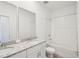 Bathroom with double sinks, granite countertops, and a bathtub with shower at 4545 Cross Prairie Pkwy, St Cloud, FL 34772