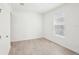 A bedroom with neutral walls, and gray tile flooring with a single window that allows plenty of natural light at 4545 Cross Prairie Pkwy, St Cloud, FL 34772