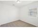 Bright bedroom featuring neutral carpet, fresh white walls, and a window for natural light at 4545 Cross Prairie Pkwy, St Cloud, FL 34772
