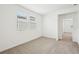 An airy bedroom with neutral walls, plush carpeting, and a window letting in natural light at 4545 Cross Prairie Pkwy, St Cloud, FL 34772