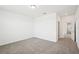 A spacious bedroom featuring neutral carpet and an open doorway to the hallway at 4545 Cross Prairie Pkwy, St Cloud, FL 34772