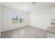 Bright dining area featuring neutral walls, gray tile flooring, and large windows providing ample natural light at 4545 Cross Prairie Pkwy, St Cloud, FL 34772
