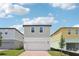 Modern two-story home with a two-car garage, stylish brick driveway, and lush landscaping at 4545 Cross Prairie Pkwy, St Cloud, FL 34772