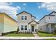 Charming two-story home features a welcoming front porch and beautiful landscaping at 4545 Cross Prairie Pkwy, St Cloud, FL 34772