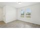 A versatile flex room space with neutral walls, gray tile flooring and natural light from the double windows at 4545 Cross Prairie Pkwy, St Cloud, FL 34772