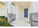 Inviting front porch with stone-clad columns and a stylish front door with house number at 4545 Cross Prairie Pkwy, St Cloud, FL 34772