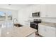 Bright kitchen with white cabinetry, granite countertops, stainless appliances, and a central island at 4545 Cross Prairie Pkwy, St Cloud, FL 34772