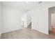An open-concept living room features neutral walls, gray tile flooring, staircase and an adjacent kitchen at 4545 Cross Prairie Pkwy, St Cloud, FL 34772