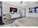 Inviting bedroom featuring a comfortable bed, white dresser, vanity table, and modern decor accents at 4875 Lacewing Dr, Winter Garden, FL 34787