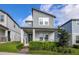 Charming two-story home features a modern design, landscaped yard and welcoming front porch at 4875 Lacewing Dr, Winter Garden, FL 34787