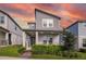 Charming two-story home features a modern design, landscaped yard and welcoming front porch at 4875 Lacewing Dr, Winter Garden, FL 34787